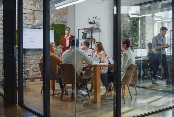 Business Insurance - Employees Having a Meeting in a Modern Conference Room